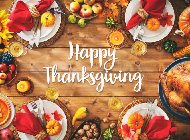 A festive Thanksgiving table with autumn decorations, pumpkins, fruits, nuts, red napkins, and a roast turkey, with Happy Thanksgiving written in white script at the center—perfect for celebrating the spirit of Thanksgiving.